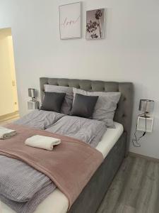 Una cama grande con una manta en un dormitorio en Eden City Home, en Győr