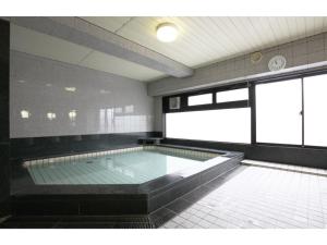 a large swimming pool in a building at AZ INN HANDA INTER - Vacation STAY 69371v in Handa