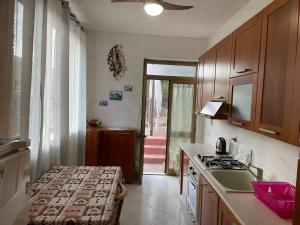 a kitchen with a sink and a stove top oven at Appartamento ROSA in Lipari