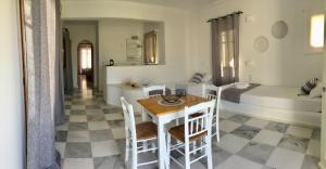 a room with a table and chairs and a bed at Rodia Studios & Apartments in Parikia