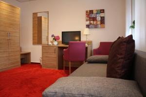 Cette chambre comprend deux lits et un bureau. dans l'établissement Hotel Zum kühlen Grunde, à Minden