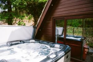 a large bath tub sitting outside of a house at Bright Star Lodge in Spean Bridge