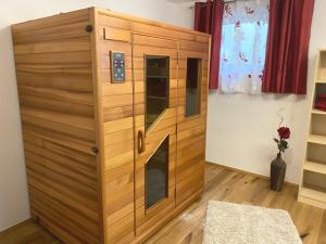 a wooden cabinet with a fireplace in a room at Ferienhaus Alex in Wiesing