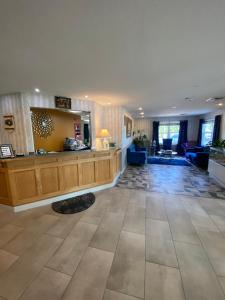 a large lobby with a reception desk and a living room at Coos Motor Inn in Lancaster
