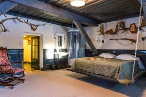 a bedroom with a swinging bed and antlers on the wall at Laitse castle in Laitse