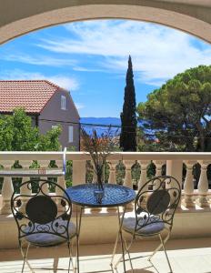 a table and chairs on a balcony with a view at Villa Mira in Bol