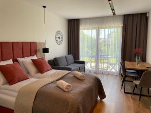 a bedroom with a bed and a living room at Royal Blue Port in Rowy