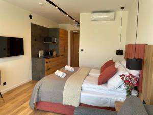 a bedroom with a bed with towels on it at Royal Blue Port in Rowy