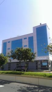 a building with a car parked in front of it at Hotel Torresur Tacna in Tacna +45 photos