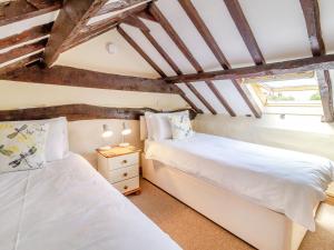 Ένα ή περισσότερα κρεβάτια σε δωμάτιο στο Norbank Cottage