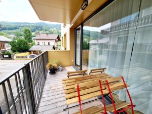 a wooden bench sitting on the balcony of a house at Beim Lanner - Maria in Mondsee