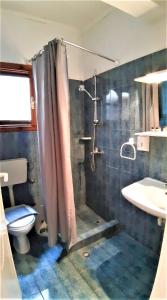 a bathroom with a shower and a toilet and a sink at Zefyros Studios in Neos Marmaras +86 photos