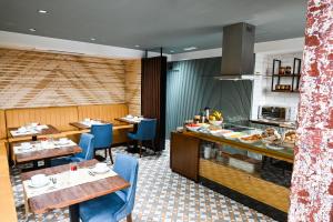 a restaurant with two tables and a counter with food at 6/4 de Lamego in Lamego