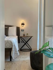 a bedroom with a bed and a side table at Maison Opéra in Palermo