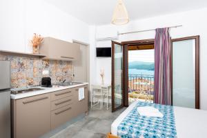a kitchen with a view of the ocean at Avli Apartments in Pyrgadikia