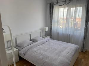 Postel nebo postele na pokoji v ubytování Libertatii 88 Luxury Apartment