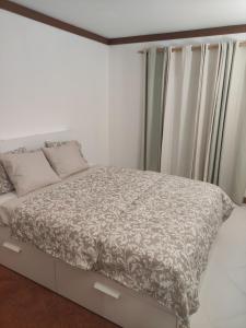 a bedroom with a bed with a gray and white comforter at Vilamoura Marina, Av Tivoli in Vilamoura +12 photos