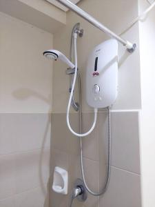 a shower head on a wall in a bathroom at Home in the Heart of Cagayan De Oro City in Cagayan de Oro