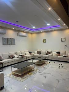 a living room with couches and a table in it at شاليه دانة الرس in Ar Rass
