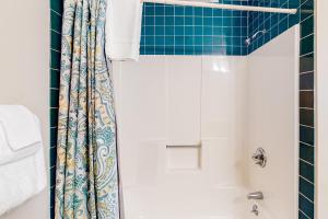 a bathroom with a shower with a shower curtain at Heavenly Hideaway in Ludlow +9 photos