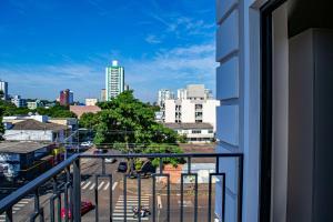 a view of a city from a balcony at Apartamentos Studio no centro de Foz do Iguaçu in Foz do Iguaçu