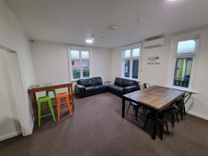 a living room with a table and a couch at Stay Timaru in Timaru