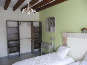 a bedroom with a bed and a desk and a chandelier at Gîte Moncé-en-Belin, 4 pièces, 6 personnes - FR-1-410-207 in Moncé-en-Belin