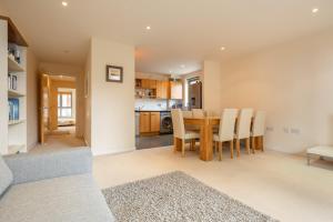 a kitchen and dining room with a table and chairs at 2 BR flat next to Train Station & Gated Parking in Cambridge
