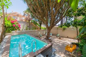 a swimming pool in a yard with a tree at Dbhousetaormina in Taormina