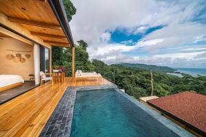 a villa with a swimming pool on a deck at LALOON Luxury Suites - Adults Only in Santa Teresa Beach