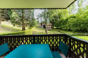 un tavolo blu su un balcone con vista su un cortile di Grazioso appartamento con balconi a 5 minuti dalla cabinovia Bettex a Saint-Gervais-les-Bains