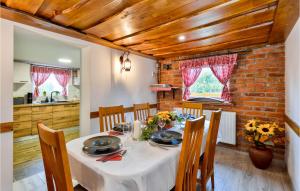 a dining room with a table and chairs at Nice Home In Nova Diklenica With Sauna in Nova Diklenica