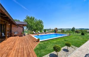 a backyard with a swimming pool and a wooden deck at Nice Home In Nova Diklenica With Sauna in Nova Diklenica +30 photos
