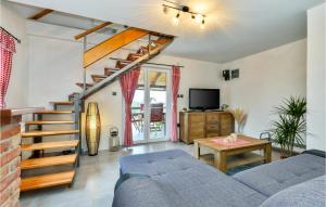 a living room with a blue couch and a staircase at Nice Home In Nova Diklenica With Sauna in Nova Diklenica