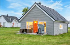 a gray house with a porch and a yard at Mein Herzensort in Olpenitz +36 photos