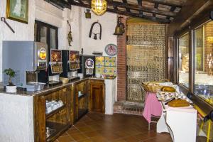 a kitchen with a counter and a table with food at Hotel da Peppe in Letojanni