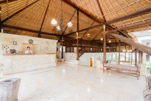 a large pavilion with a woman in the center of the room at Pertiwi Resort & Spa in Ubud