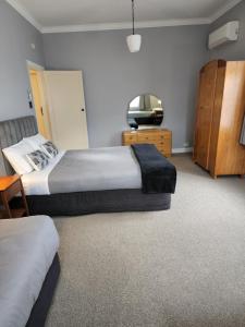 a hotel room with two beds and a television at Gardner Court Motel in Napier