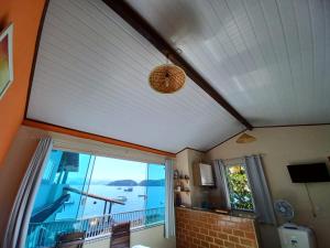 a room with a large window with a view of the ocean at Flat do Léo in Praia de Araçatiba