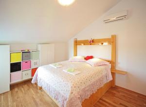 a bedroom with a large bed and a dresser at Apartment On the top in Vrboska