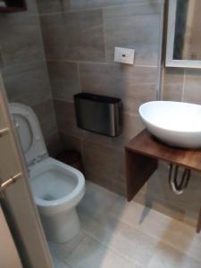 a bathroom with a white toilet and a sink at CIELITO LINDO in Santa Rosa de Cabal