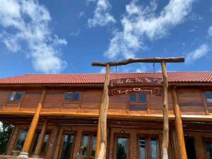 a house with a sign on the front of it at Green Bamboo Lodge Resort in Cat Tien