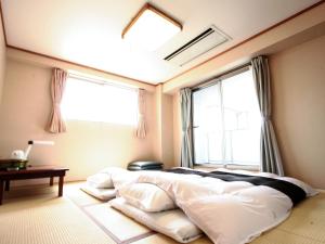 Postel nebo postele na pokoji v ubytování Hotel Abest Kochi
