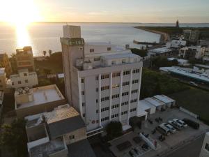 an aerial view of a white building and the ocean at Penghu An-I Hotel in Magong