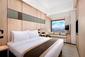a hotel room with a bed and a television at Harbour Plaza Metropolitan Shanghai in Shanghai
