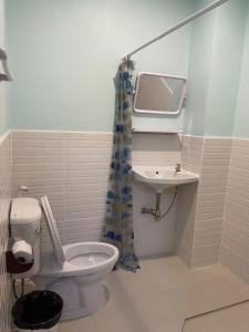 a bathroom with a toilet and a sink at Scala Hostel in Bangkok