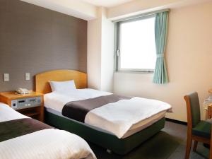 Postel nebo postele na pokoji v ubytování Hotel Abest Kochi + 37 fotografií