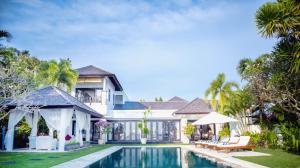 an exterior view of a villa with a swimming pool at Villa Sunset by Premier Hospitality Asia in Nusa Dua