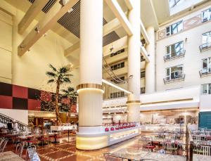 a view of the lobby of a hotel with tables and chairs at Beijing XinQiao Hotel in Beijing