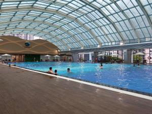 a large swimming pool with people in the water at Apartment 1BR-FL24th-R105 Building-Vinhomes Ocean Park in Hanoi